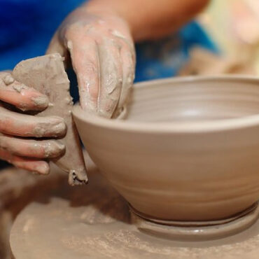 Artist throwing a bowl on the wheel