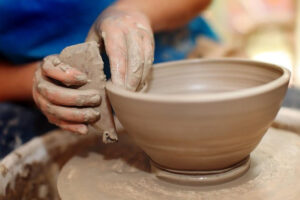 Artist throwing a bowl on the wheel